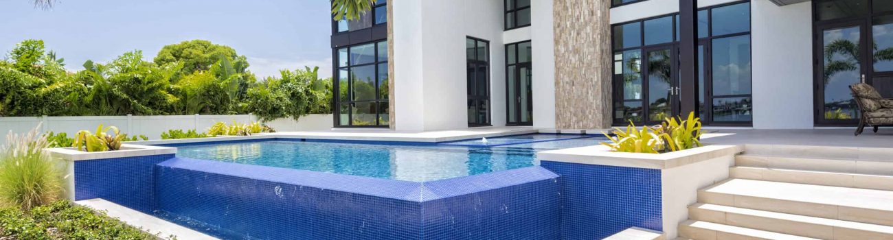 Beautiful Landscaped Modern Home with Swimming Pool. A beautiful modern home with landscaped backyard, swimming pool with waterfall and spa including an outdoor sitting area.