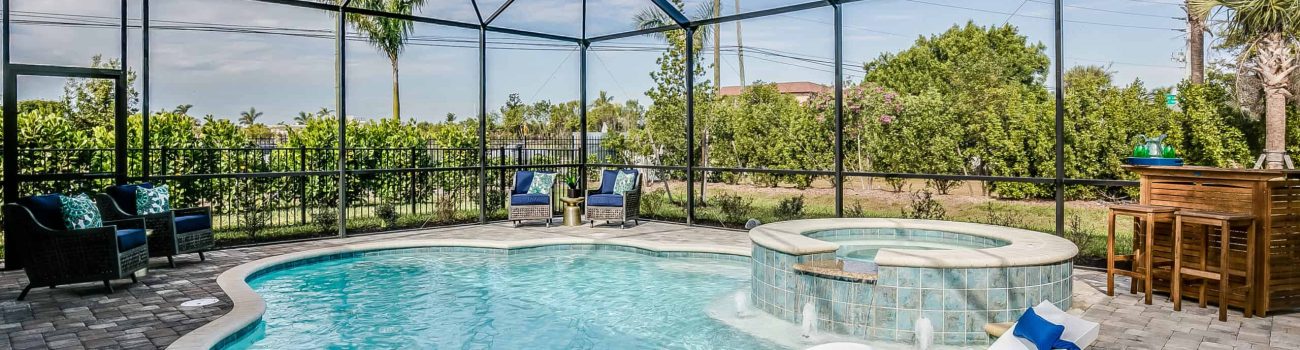 Cloud-shaped pool with net enclosure Pool and hot tub of Florida home